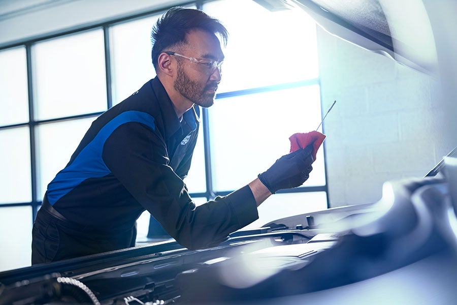 Mechanic checking oil level