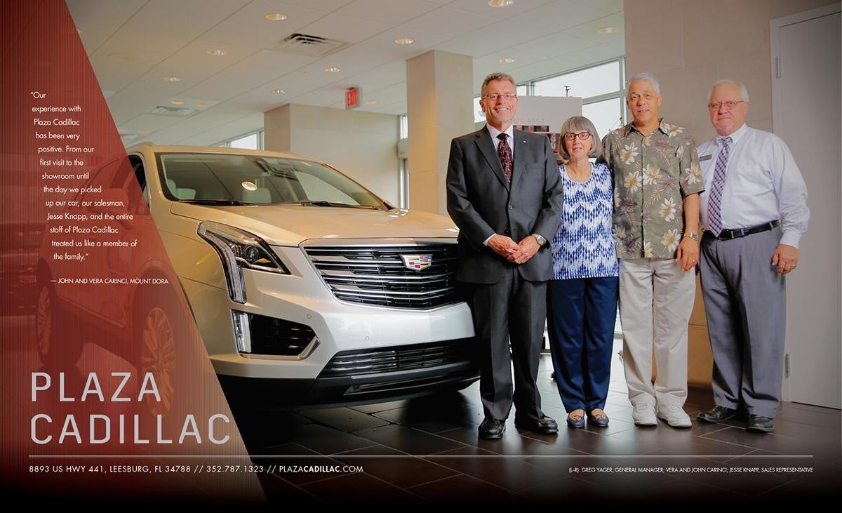 4 adults next to a white Cadillac
