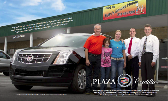 4 adults and 1 child next to a black Cadillac