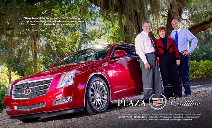 3 adults next to a red Cadillac