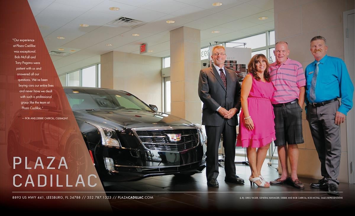 4 adults next to a black Cadillac