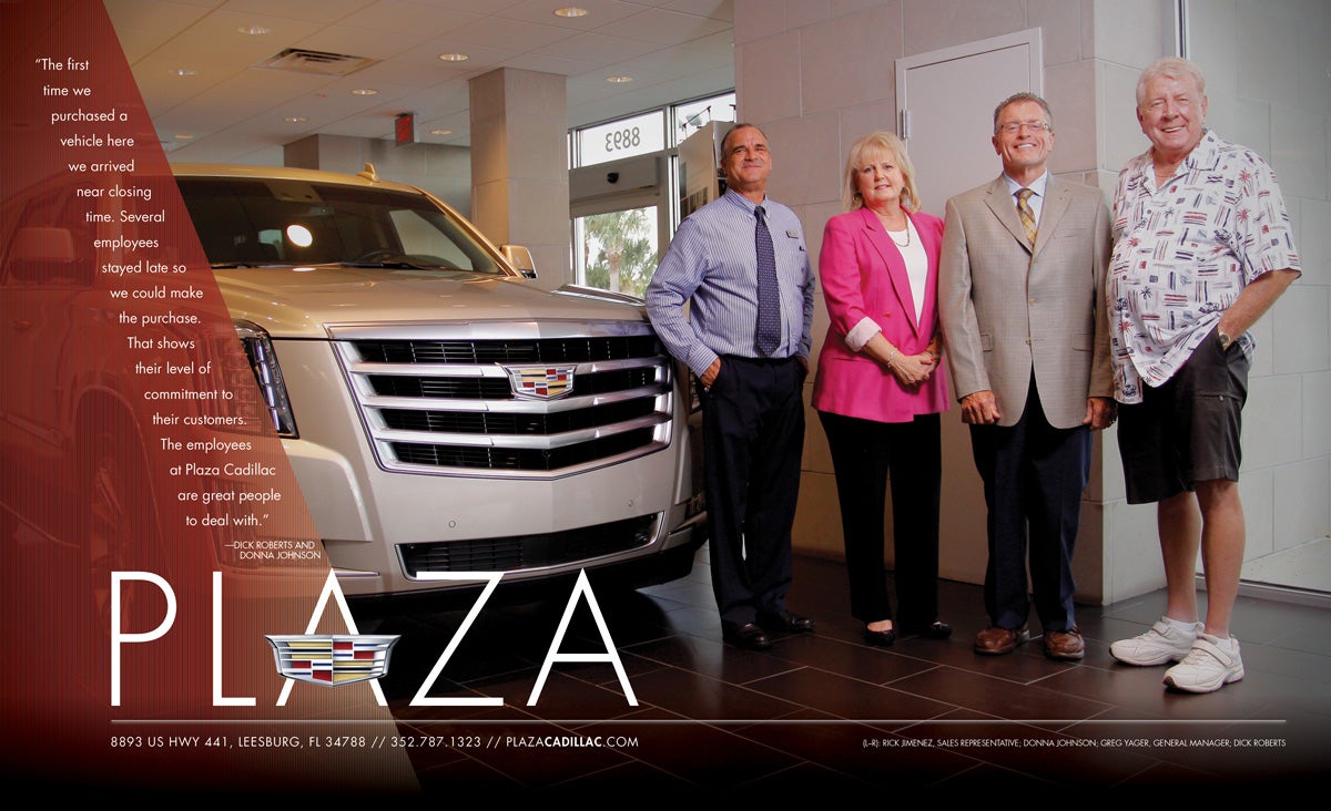 4 adults next to a white Cadillac