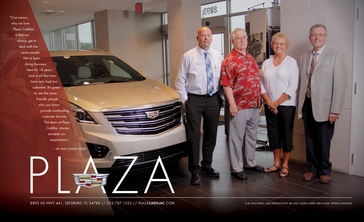 4 adults next to a white Cadillac