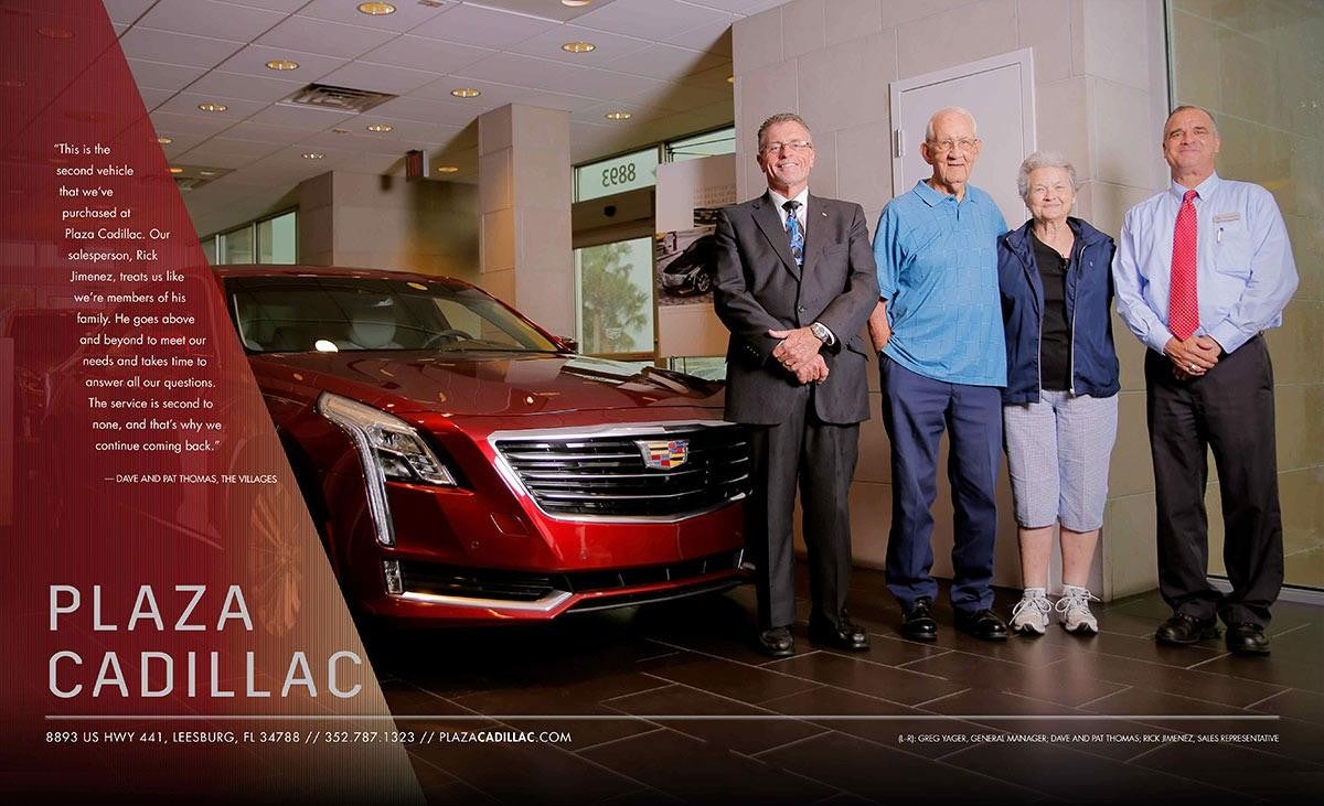 4 men next to a red Cadillac